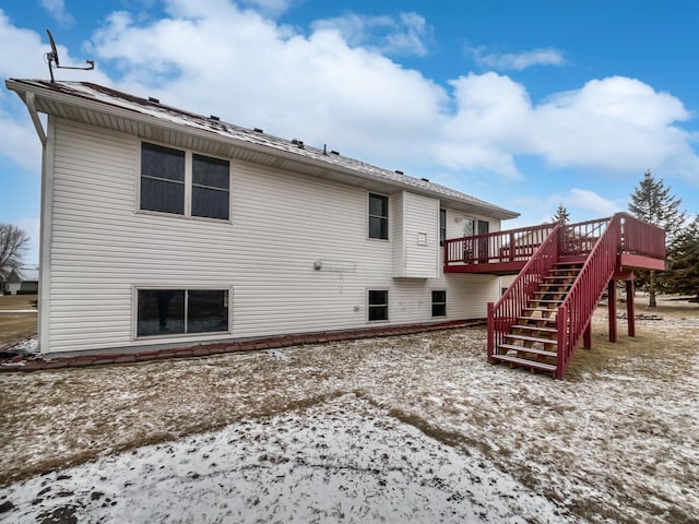 rear view of property featuring stairs and a deck