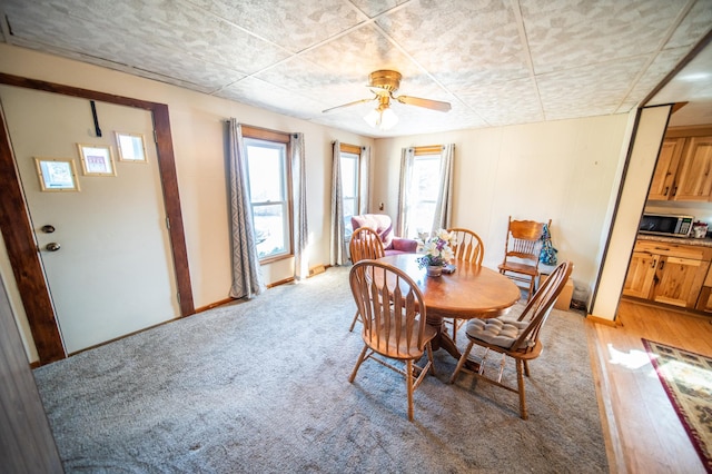 dining space featuring a wealth of natural light, a ceiling fan, and baseboards