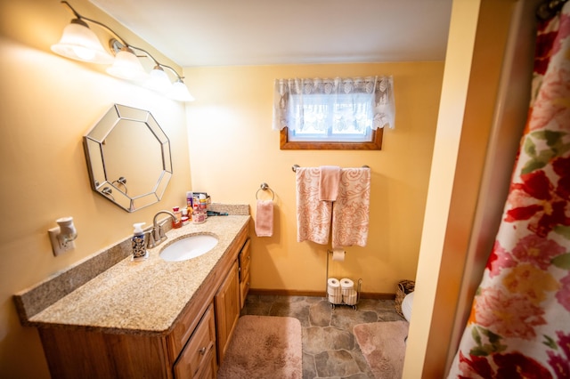 bathroom with vanity and baseboards
