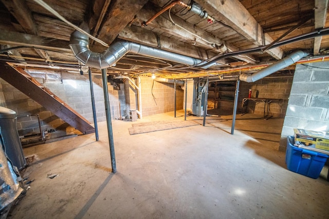 unfinished basement featuring heating unit