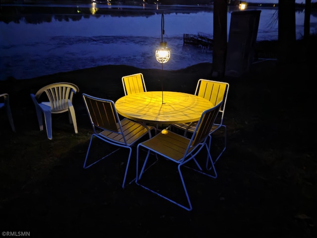 734 180th Ave, Apple River Twp, WI 54810 - patio at night with a water view and outdoor dining area