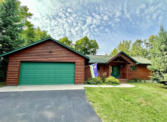 view of front of home featuring faux log siding, driveway, and a front lawn