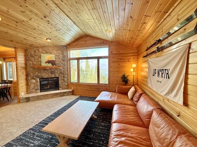 living area featuring lofted ceiling, wooden ceiling, carpet flooring, wood walls, and a fireplace