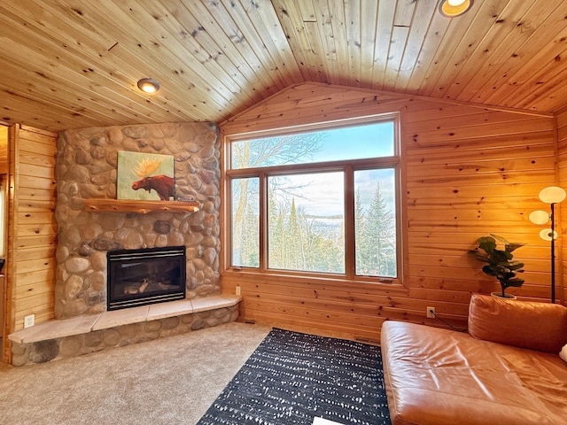 living area with lofted ceiling, wood ceiling, and a fireplace