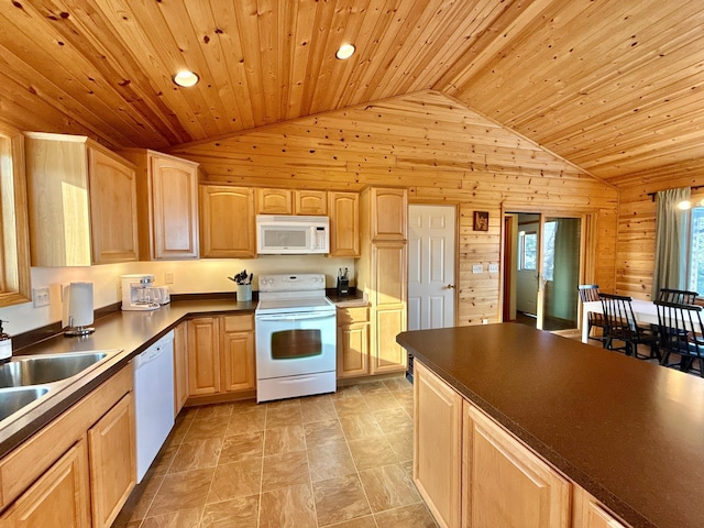 kitchen featuring lofted ceiling, white appliances, wooden walls, and light brown cabinetry