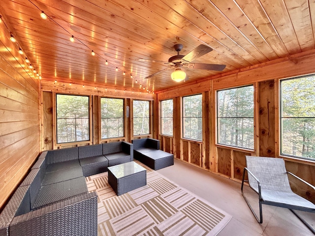 unfurnished sunroom featuring a ceiling fan and wooden ceiling