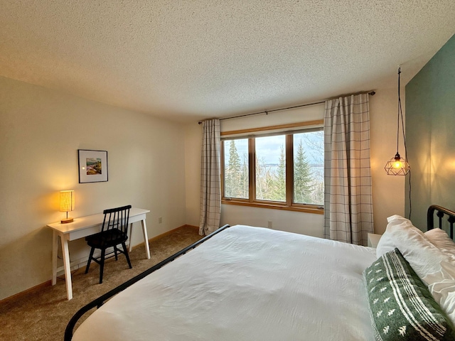 bedroom with carpet, a textured ceiling, and baseboards