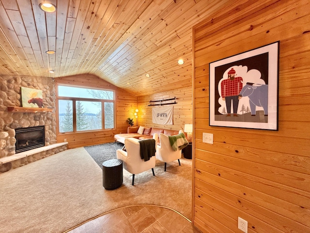 living room featuring wood walls, wood ceiling, vaulted ceiling, and a stone fireplace