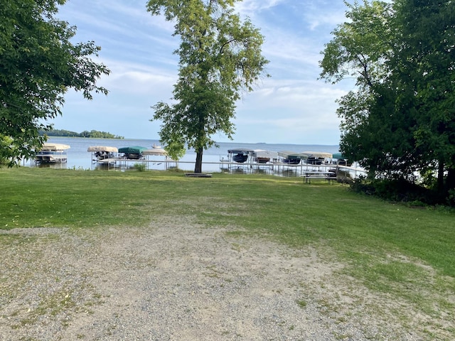 exterior space featuring a dock and a water view