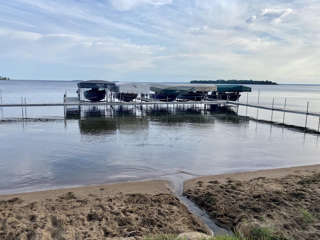 dock area with a water view and boat lift