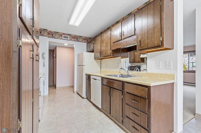 kitchen with a baseboard radiator, light countertops, visible vents, a sink, and dishwasher