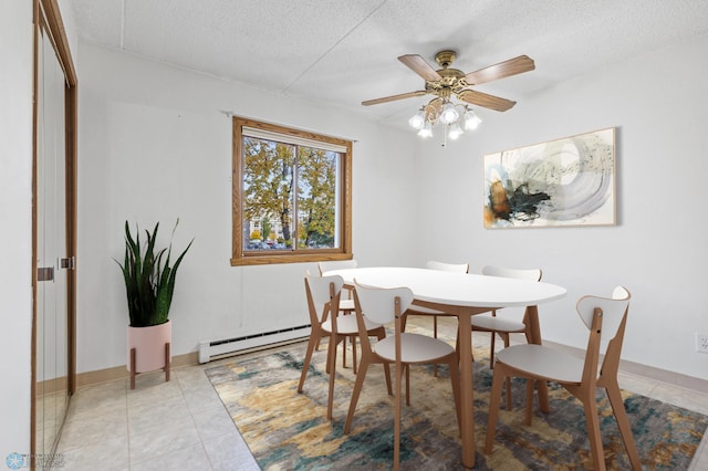 dining room with a ceiling fan, a textured ceiling, baseboard heating, and light tile patterned floors