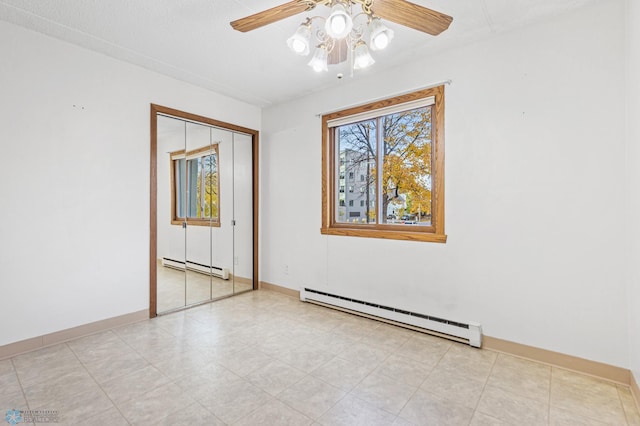 unfurnished room featuring a baseboard radiator, ceiling fan, and baseboards