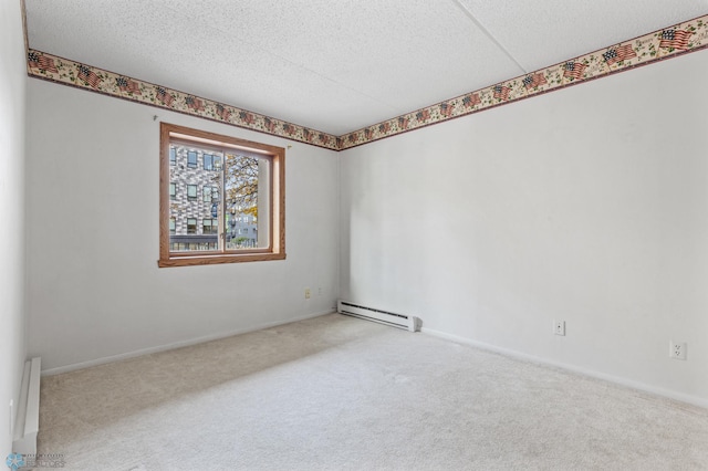 spare room with baseboards, light carpet, a textured ceiling, and baseboard heating