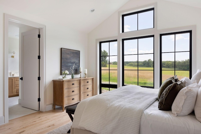 bedroom featuring light wood-style floors, access to outside, multiple windows, and high vaulted ceiling