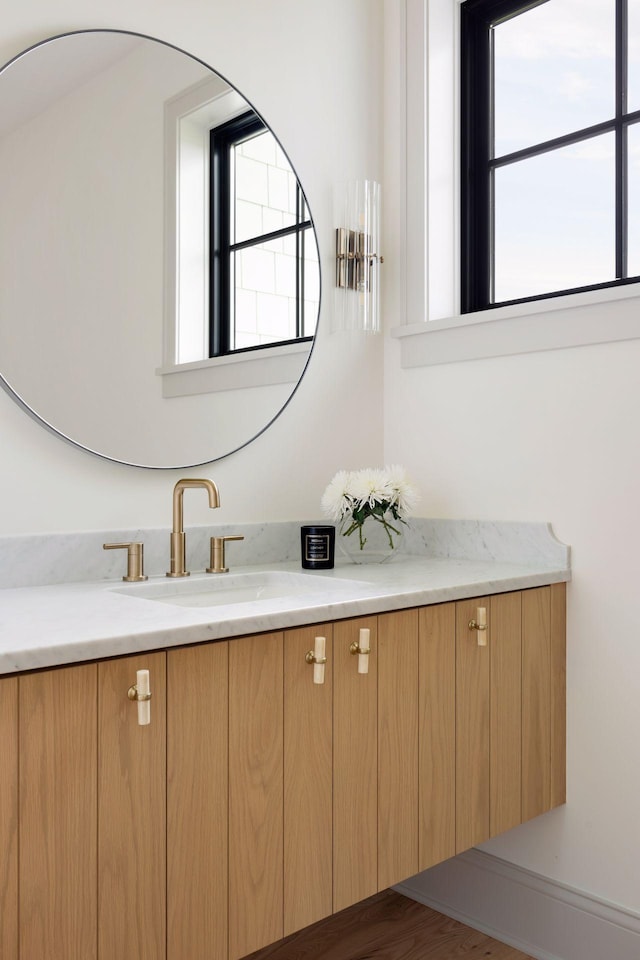 bathroom featuring a healthy amount of sunlight and vanity