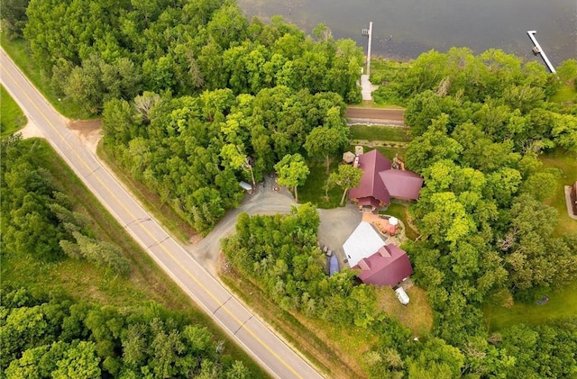 birds eye view of property featuring a view of trees