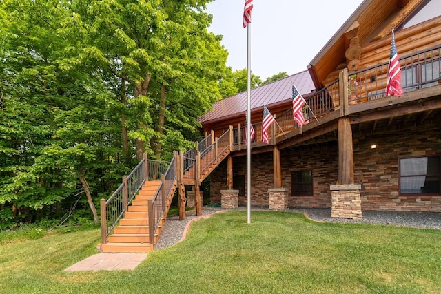 rear view of house featuring a yard, stairway, a standing seam roof, metal roof, and a wooden deck