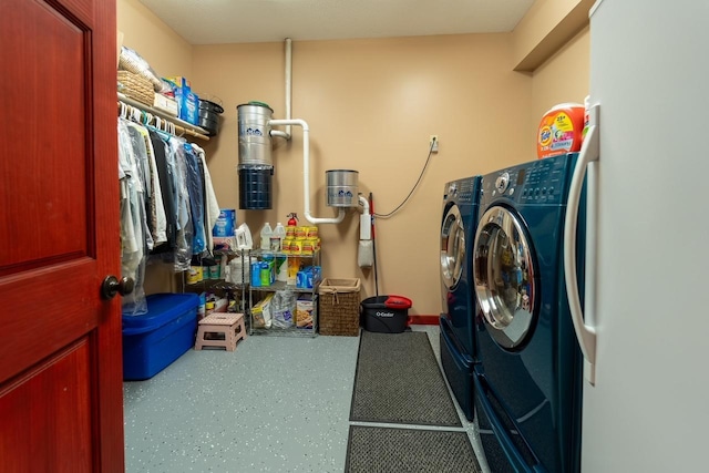 washroom featuring laundry area and washing machine and clothes dryer