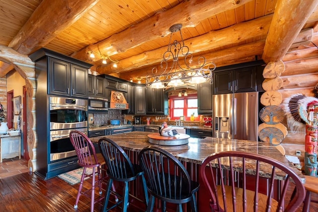 kitchen featuring arched walkways, dark wood finished floors, dark stone counters, wooden ceiling, and stainless steel appliances