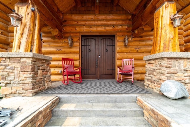 doorway to property featuring log siding