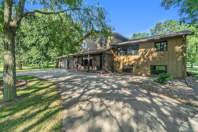 view of front of home with concrete driveway and an attached garage