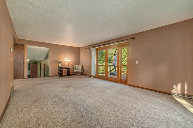 interior space with baseboards, a textured ceiling, and french doors