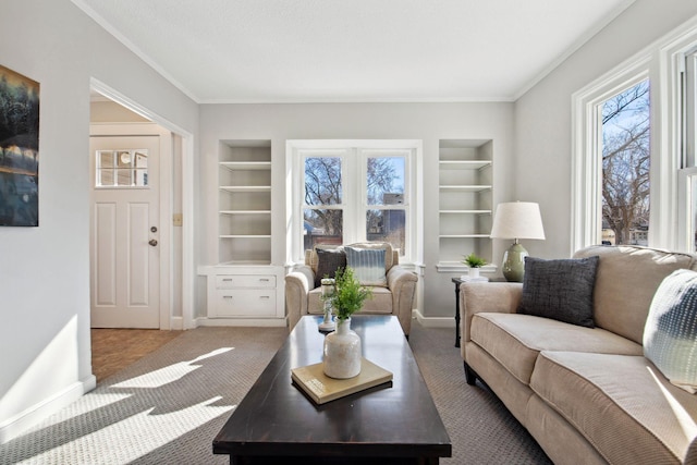 carpeted living room featuring built in features, ornamental molding, and baseboards