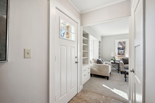 entrance foyer featuring carpet floors and ornamental molding