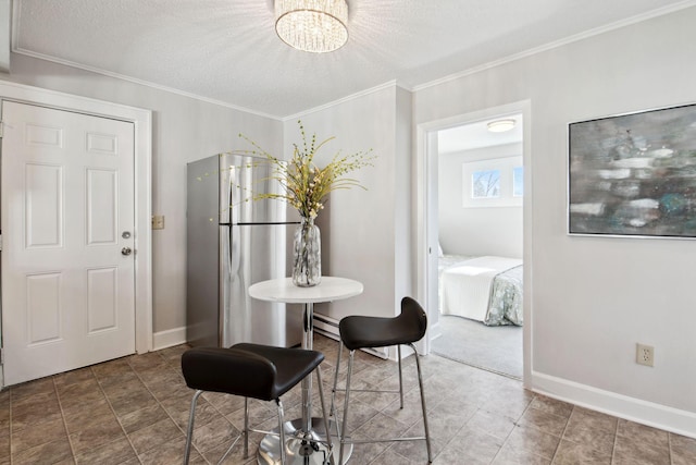 dining space with baseboards, baseboard heating, and crown molding