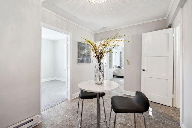 dining area featuring a baseboard heating unit, crown molding, a textured ceiling, and baseboards