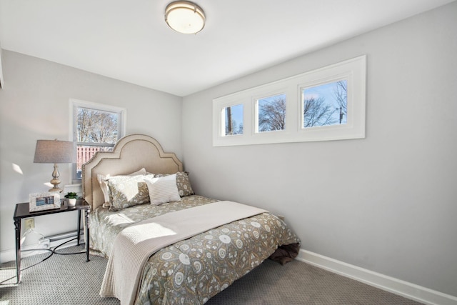 bedroom with carpet flooring, baseboards, and multiple windows