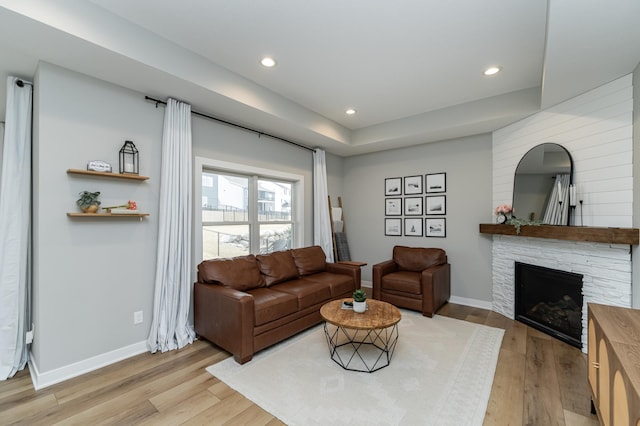 1676 Brandt Dr NE, Byron, MN 55920 - living area with light wood-type flooring, recessed lighting, arched walkways, a stone fireplace, and baseboards