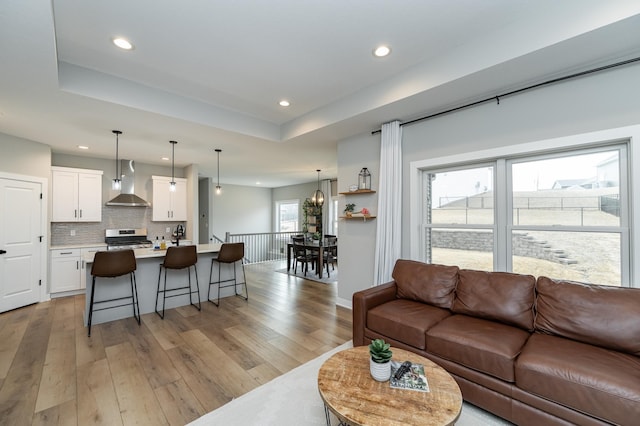 1676 Brandt Dr NE, Byron, MN 55920 - living room featuring recessed lighting, light wood-style flooring, and a raised ceiling
