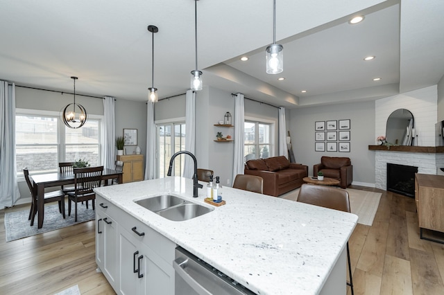 1676 Brandt Dr NE, Byron, MN 55920 - kitchen featuring a sink, dishwasher, light wood-style flooring, and a fireplace