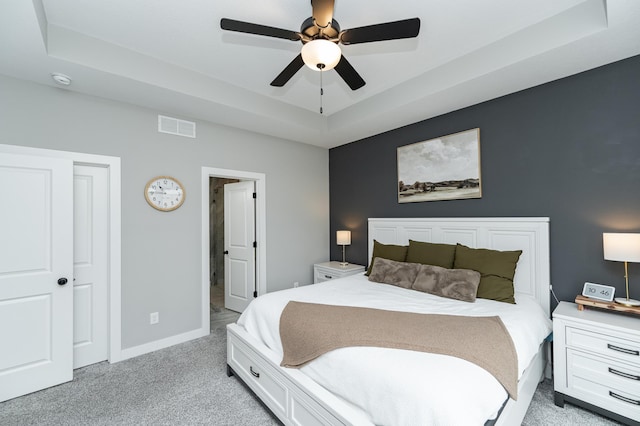 1676 Brandt Dr NE, Byron, MN 55920 - bedroom with baseboards, visible vents, ceiling fan, light carpet, and a raised ceiling