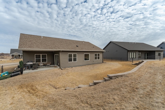 1676 Brandt Dr NE, Byron, MN 55920 - back of house featuring fence, roof with shingles, and a patio area