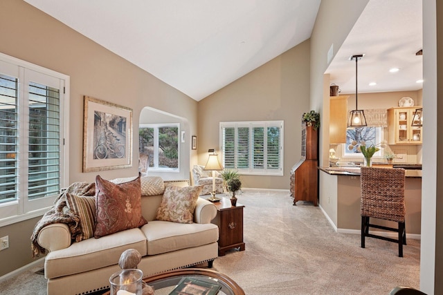 living room featuring light carpet, recessed lighting, baseboards, and lofted ceiling