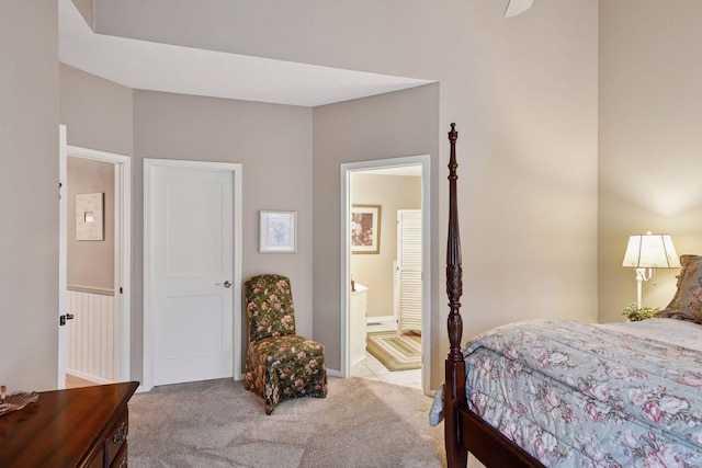 carpeted bedroom featuring ensuite bath