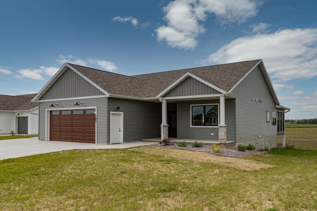 view of front of property featuring an attached garage, a front lawn, concrete driveway, and roof with shingles