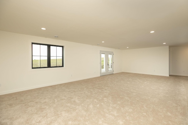 empty room featuring recessed lighting, baseboards, and french doors