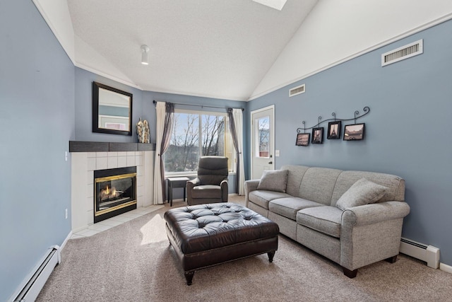 carpeted living area featuring lofted ceiling, a baseboard radiator, a tile fireplace, and visible vents