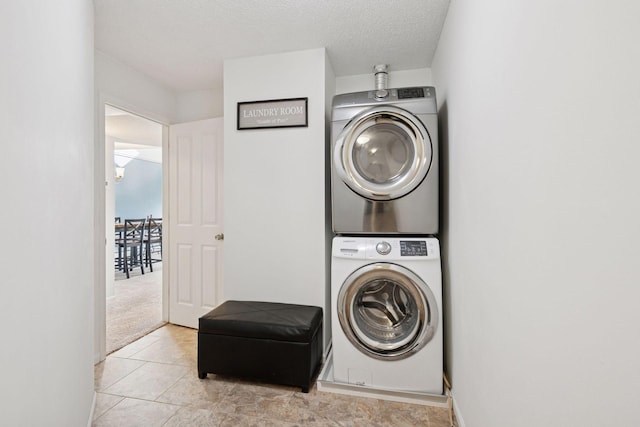 washroom with stacked washer / dryer, laundry area, and a textured ceiling