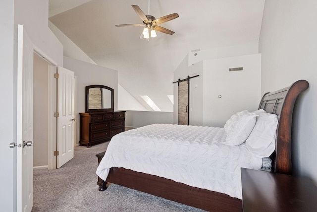 carpeted bedroom with lofted ceiling, visible vents, ceiling fan, and a barn door