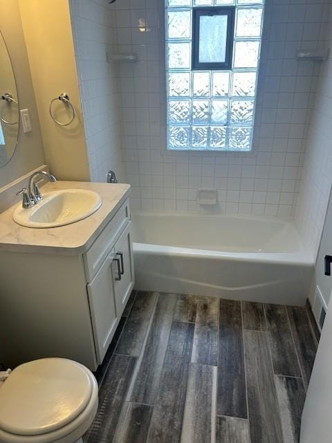 bathroom featuring plenty of natural light, vanity, shower / bath combination, and wood finished floors