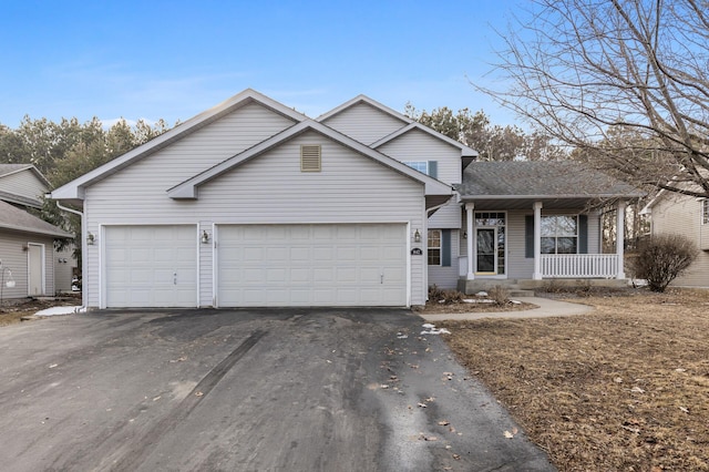 view of front of house featuring covered porch, driveway, and an attached garage