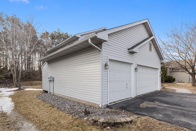 view of property exterior with aphalt driveway