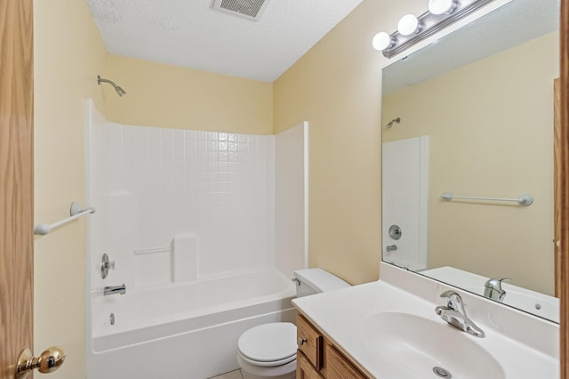 full bath featuring visible vents, tub / shower combination, toilet, vanity, and a textured ceiling