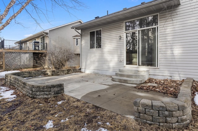 back of house with a deck, a patio area, and entry steps