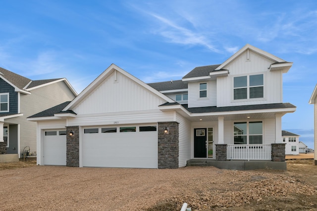 view of front of property with a garage, covered porch, board and batten siding, and dirt driveway